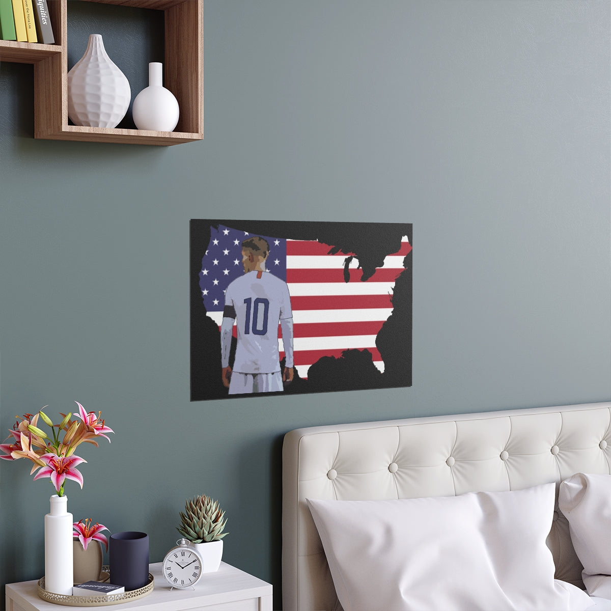 Contextual Front view of Christian Pulisic in USMNT kit in front of USA themed background of flag inside country outline poster hanging above bed.