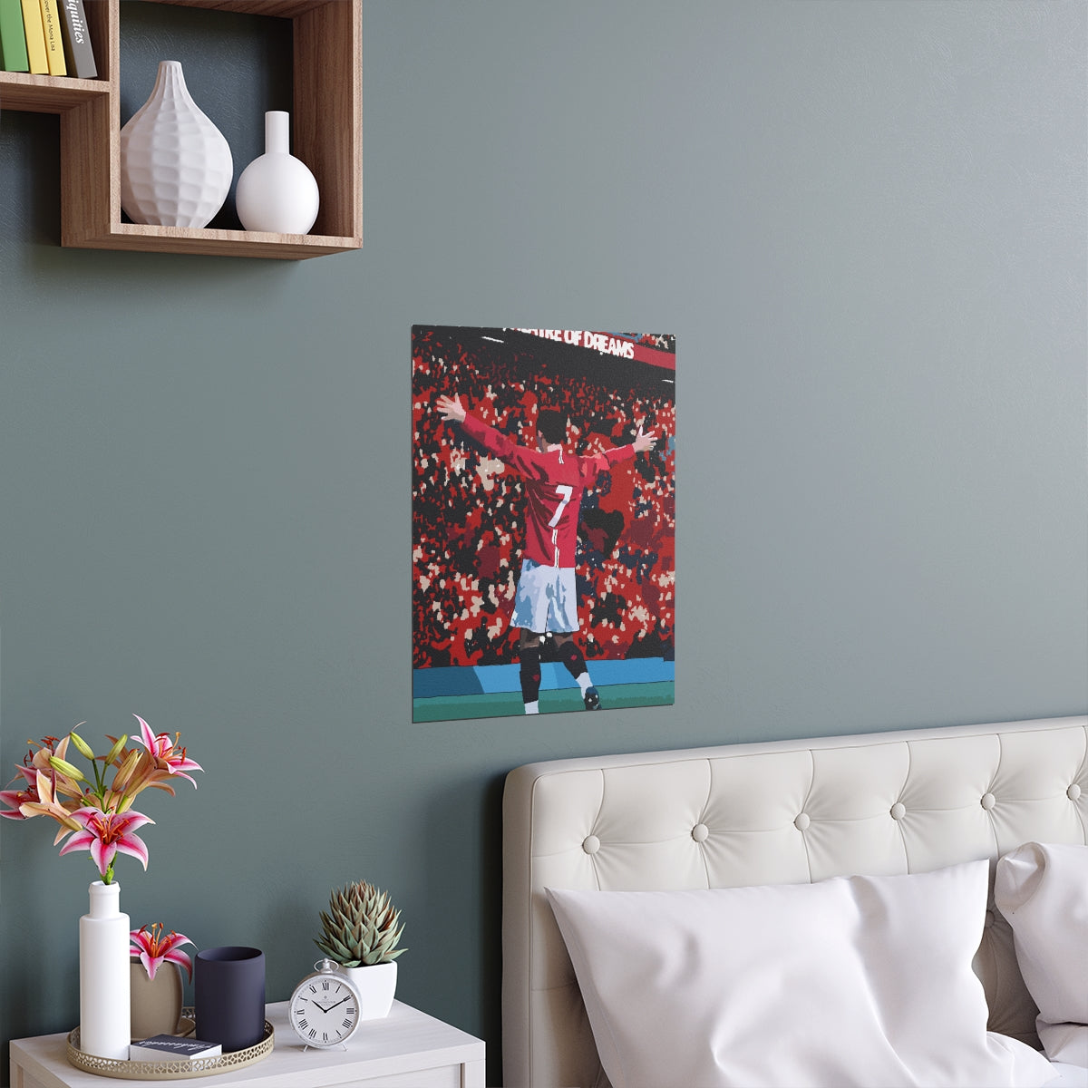 Contextual Front view of Manchester United Cristiano Ronaldo celebrating in front of Old Trafford crowd on a poster hanging above a double bed.