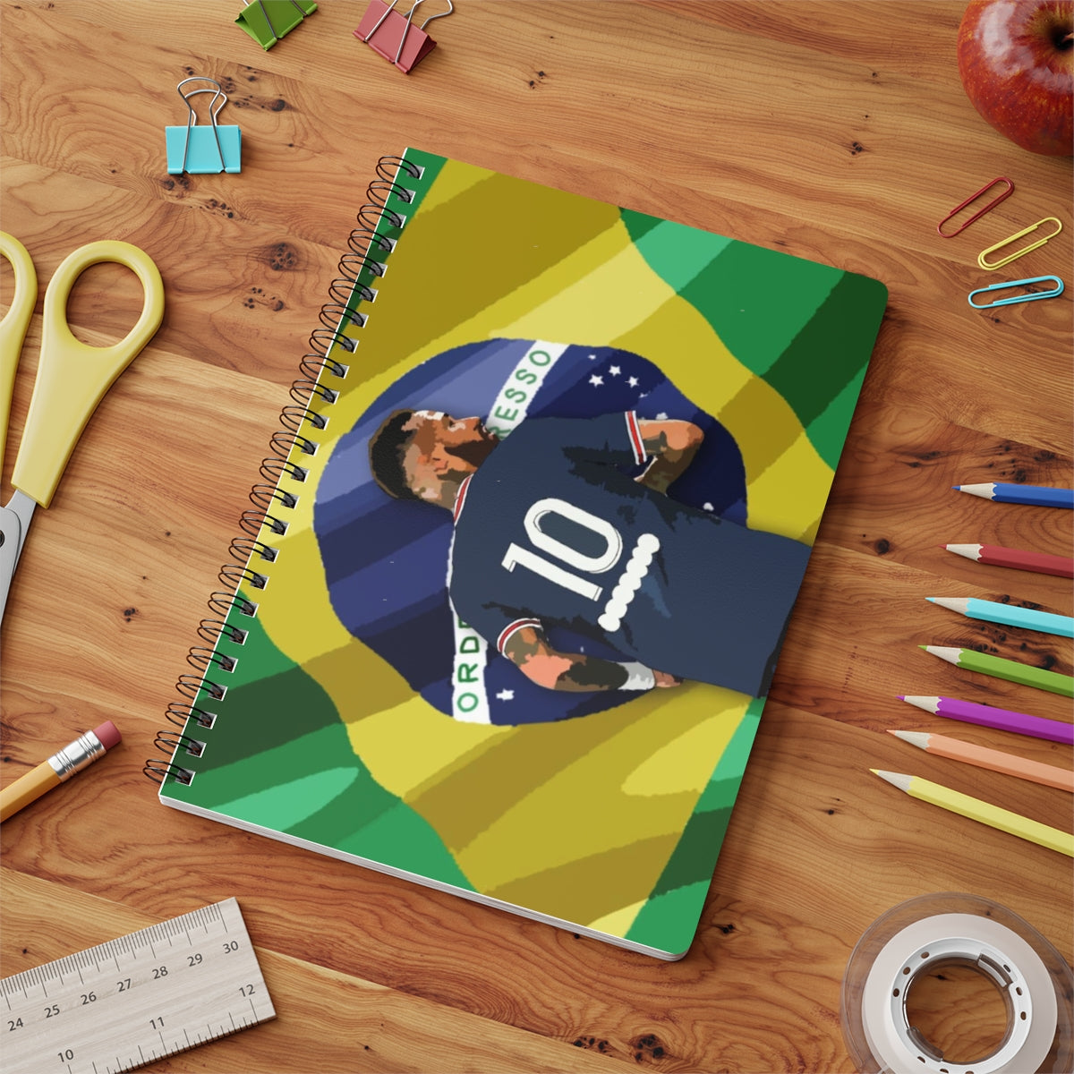 Contextual Front view of PSG Neymar in front of Brazilian flag background A5 spiral notepad on desk top.