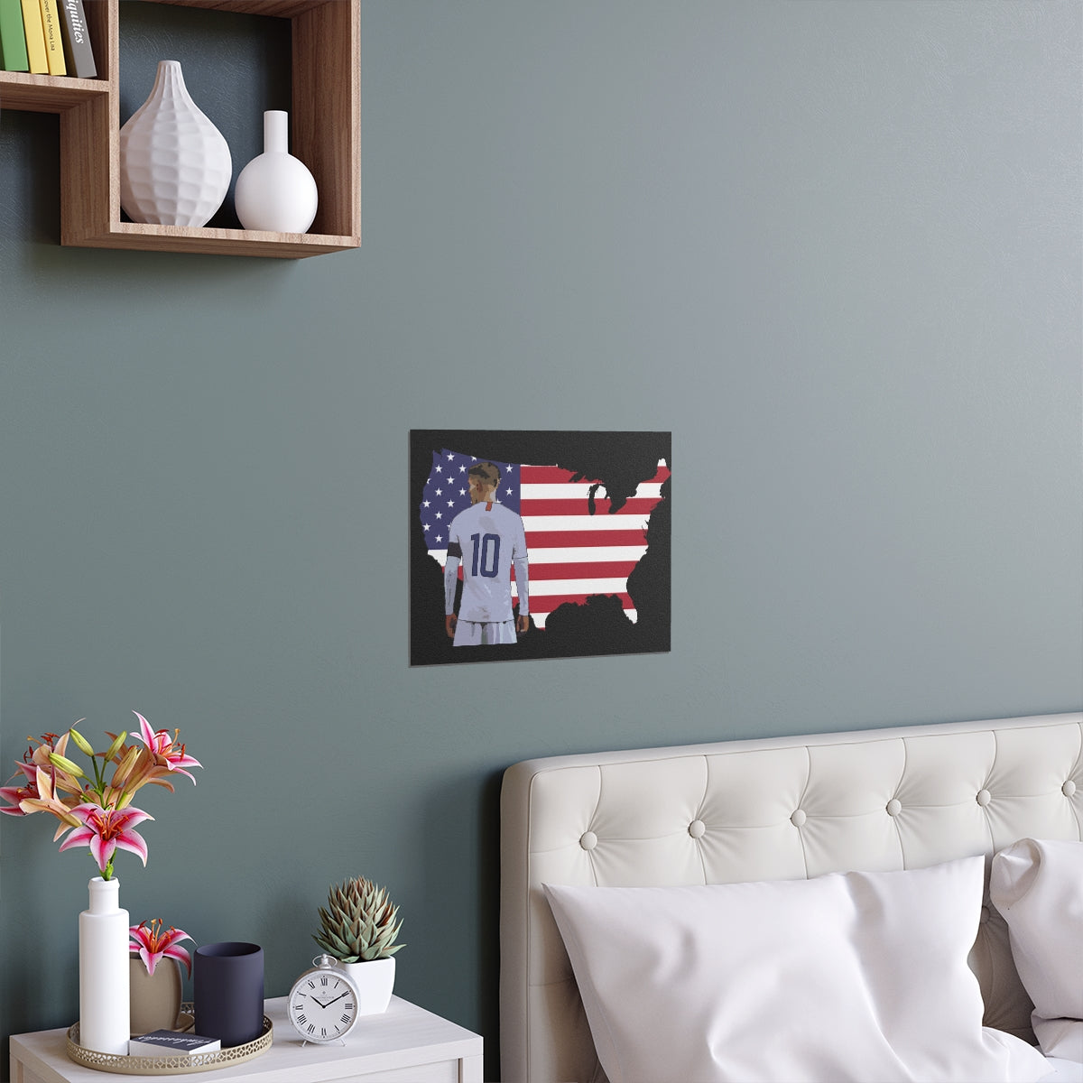 Contextual Front view of Christian Pulisic in USMNT kit in front of USA themed background of flag inside country outline poster hanging above bed.