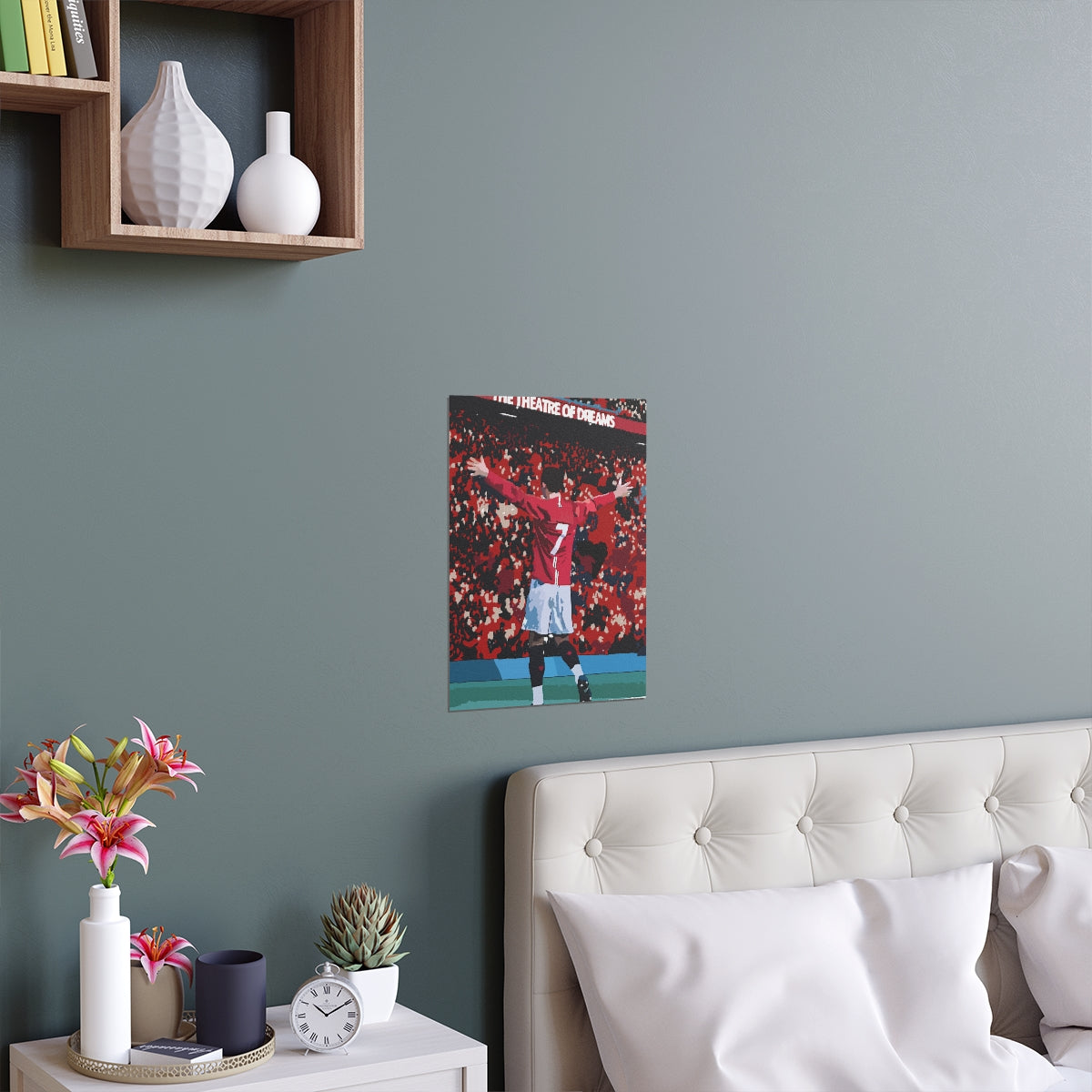 Contextual Front view of Manchester United Cristiano Ronaldo celebrating in front of Old Trafford crowd on a poster hanging above a double bed.