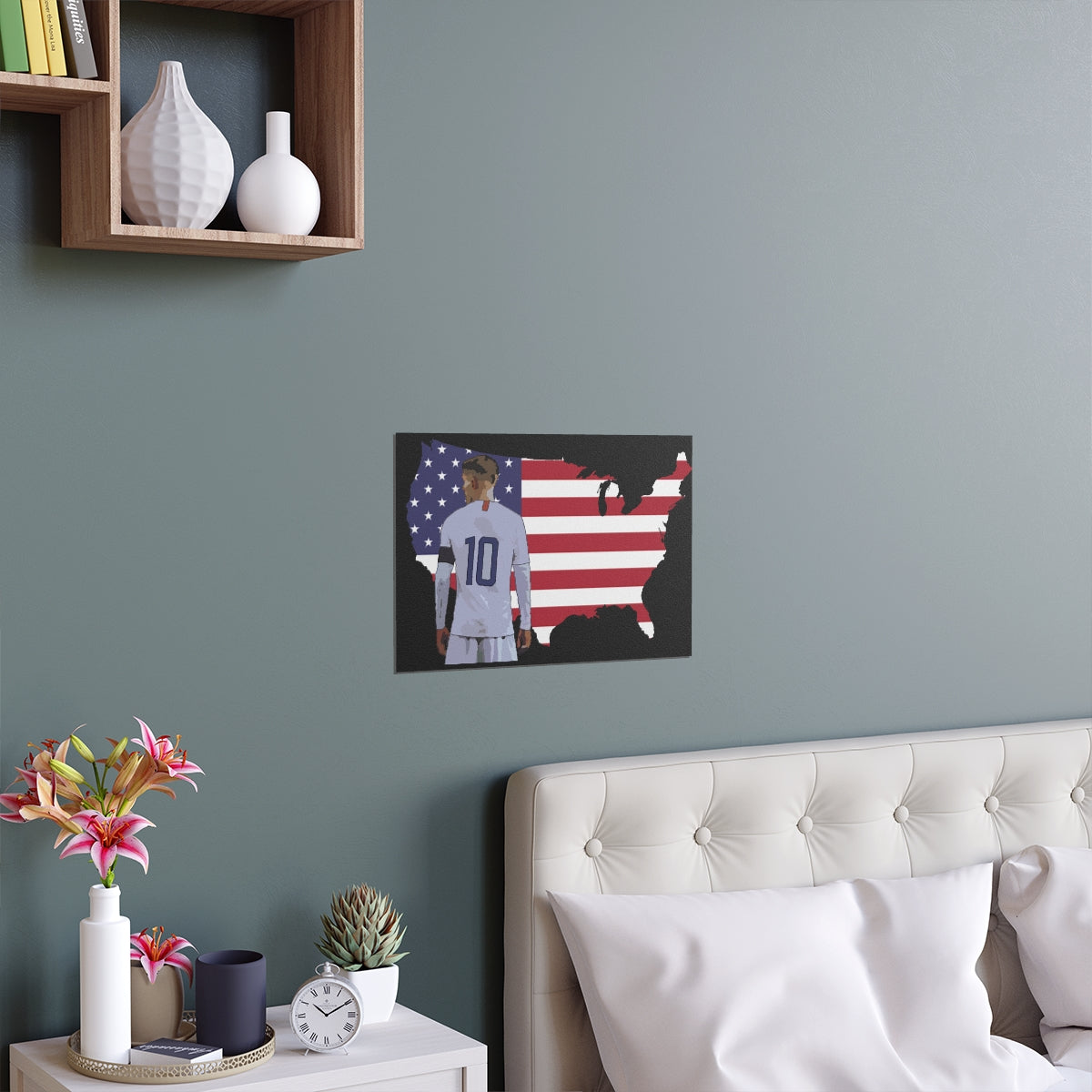 Contextual Front view of Christian Pulisic in USMNT kit in front of USA themed background of flag inside country outline poster hanging above bed.